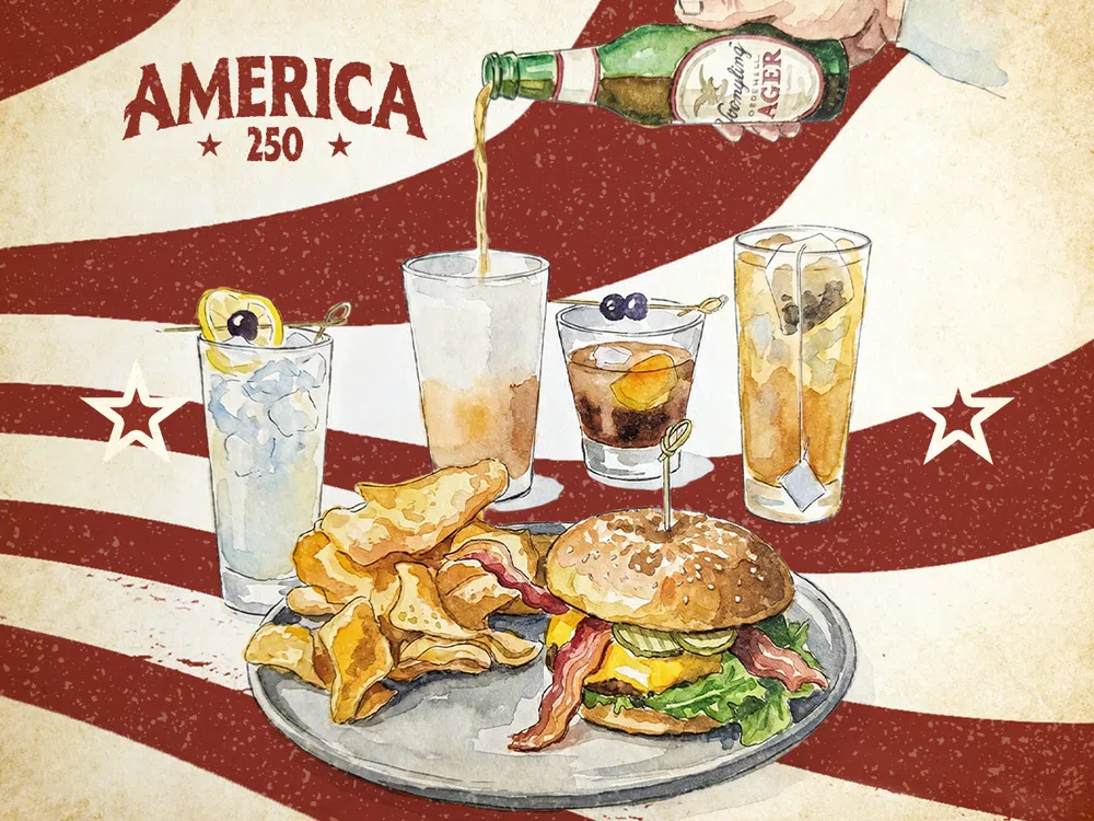 Burger with bacon, cheese, lettuce, chips, and drinks against a vintage America 250 backdrop.