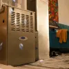 Indoor Carrier brand furnace next to a drum set and cozy living area with teal sofa and colorful wall art.