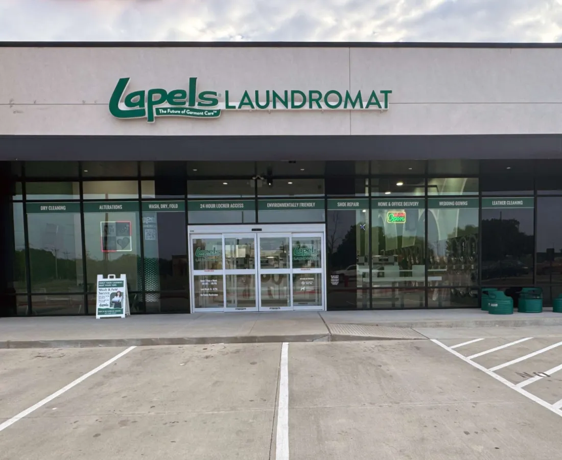 Exterior view of Lapels Laundromat storefront with parking spaces and clear signage on a sunny day