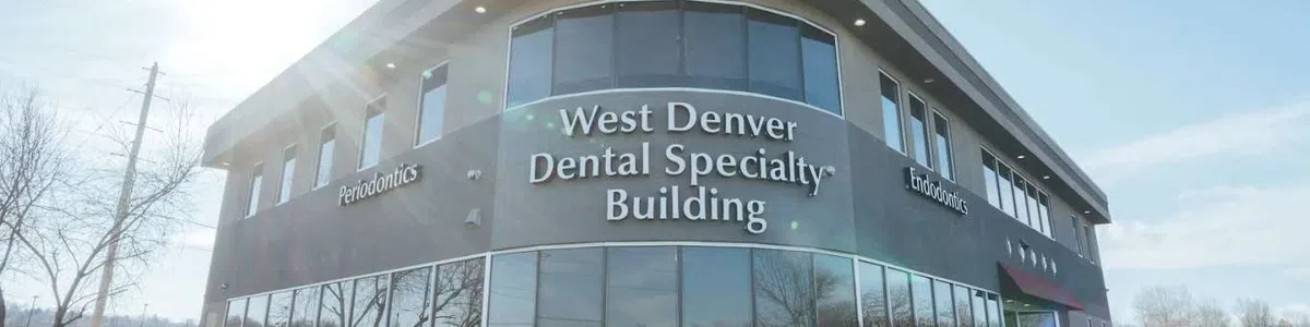Modern West Denver Dental Specialty Building with large windows and clear blue sky on a sunny day.