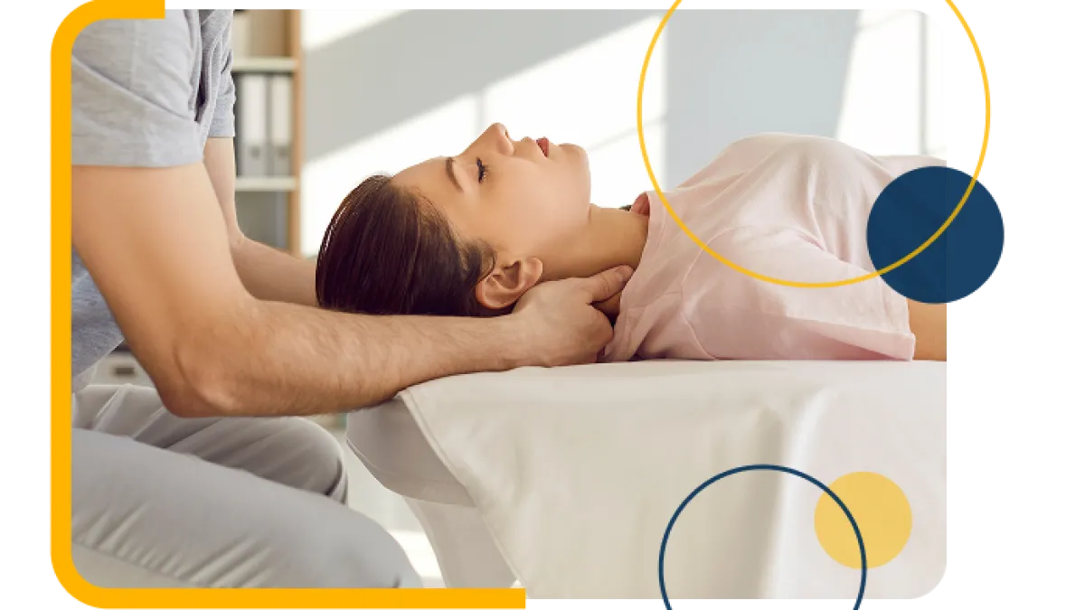Therapist performing neck massage on a relaxed woman lying on a massage table in a bright room.