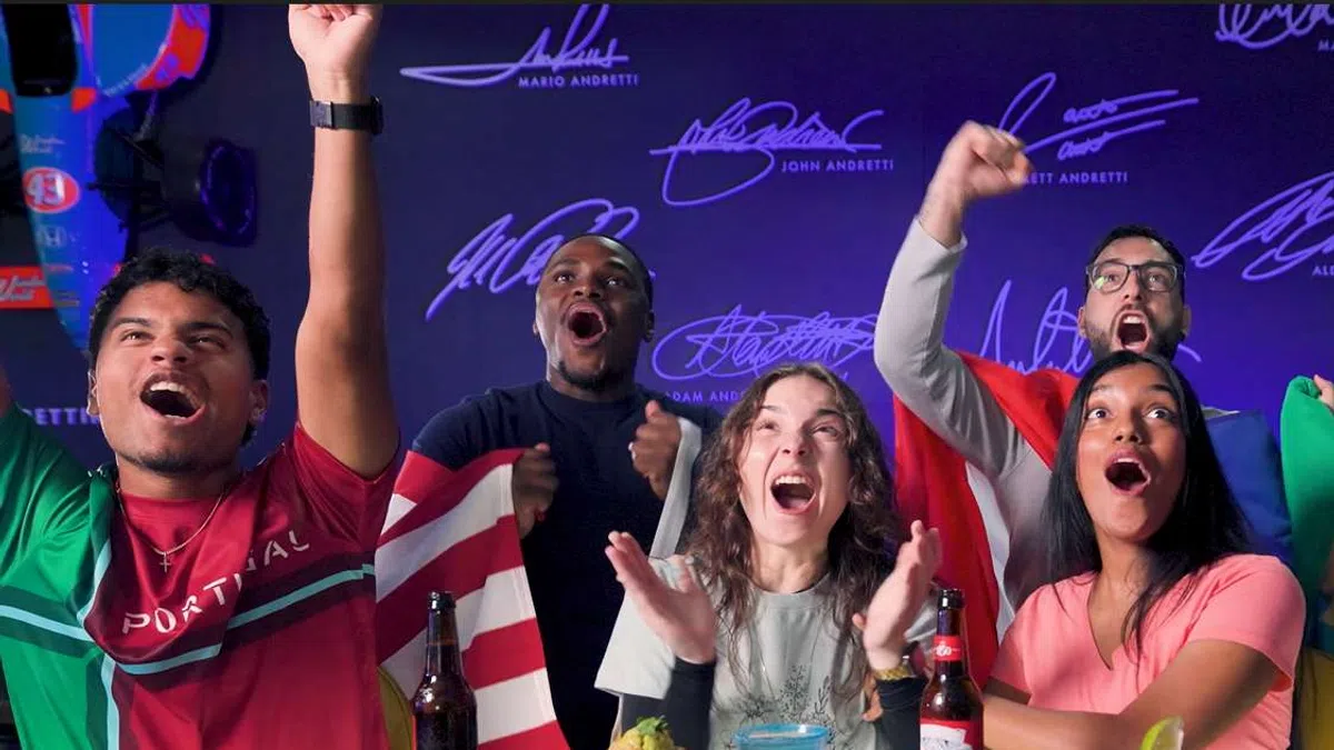 Group of diverse friends cheering and celebrating with food and drinks at a lively gathering.