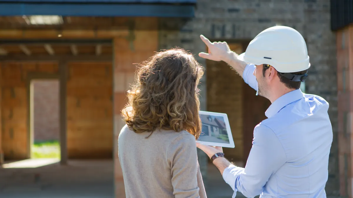 a man and a woman wearing hard hats