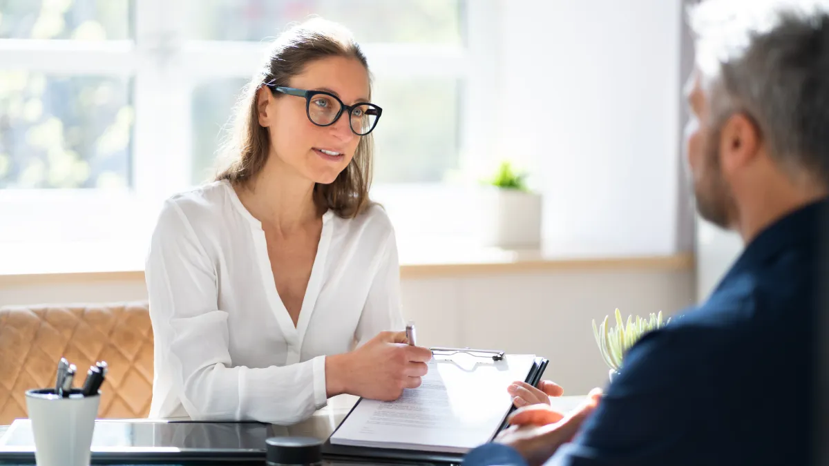 a man and a woman looking at a paper