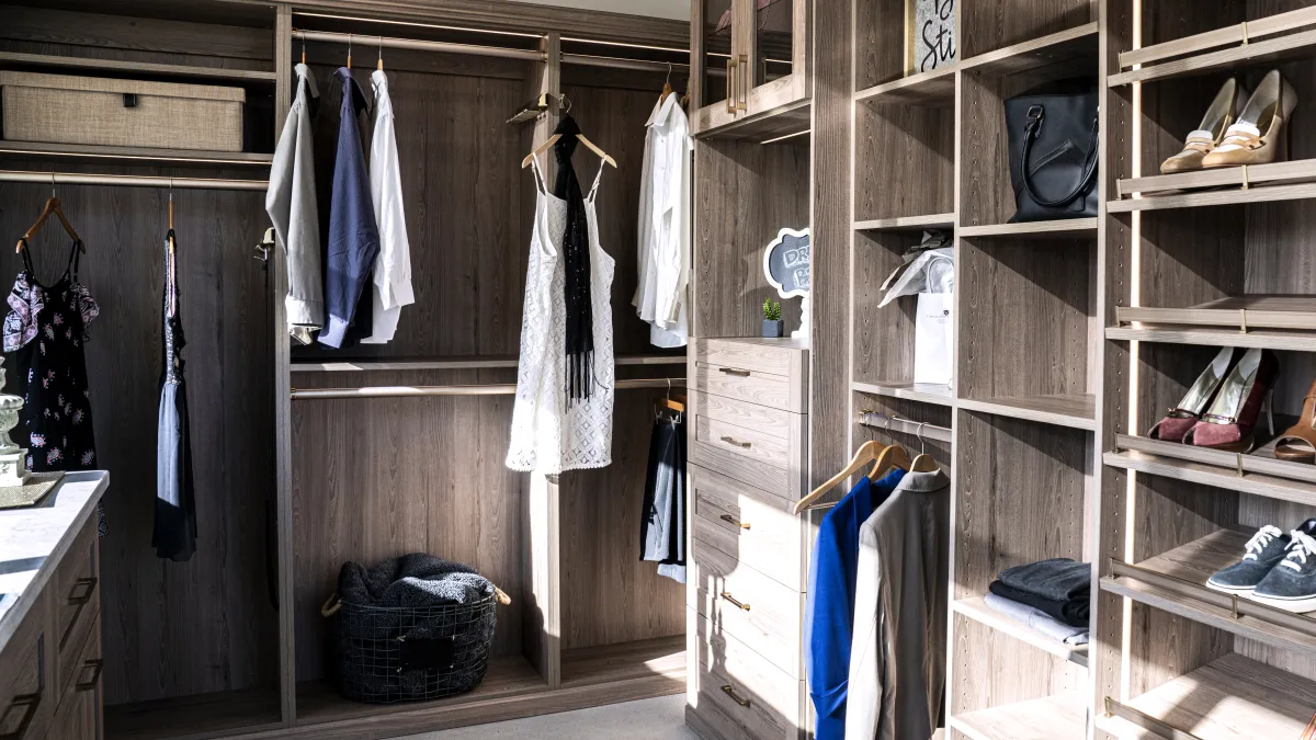 a closet with clothes and shoes