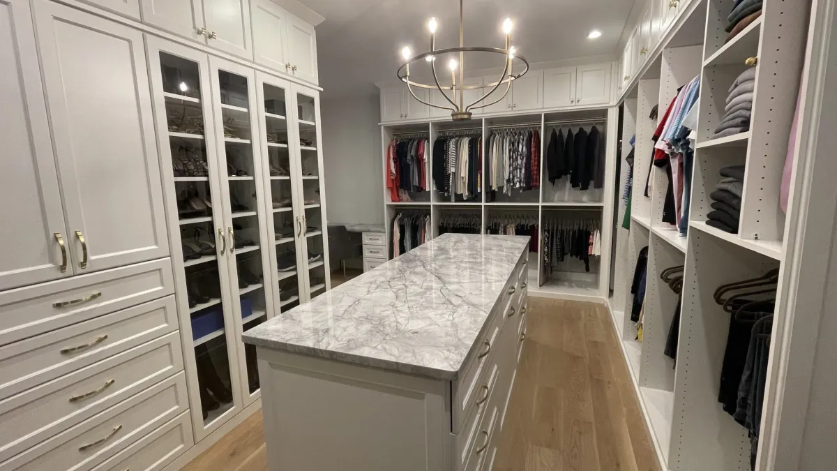 a closet with white cabinets