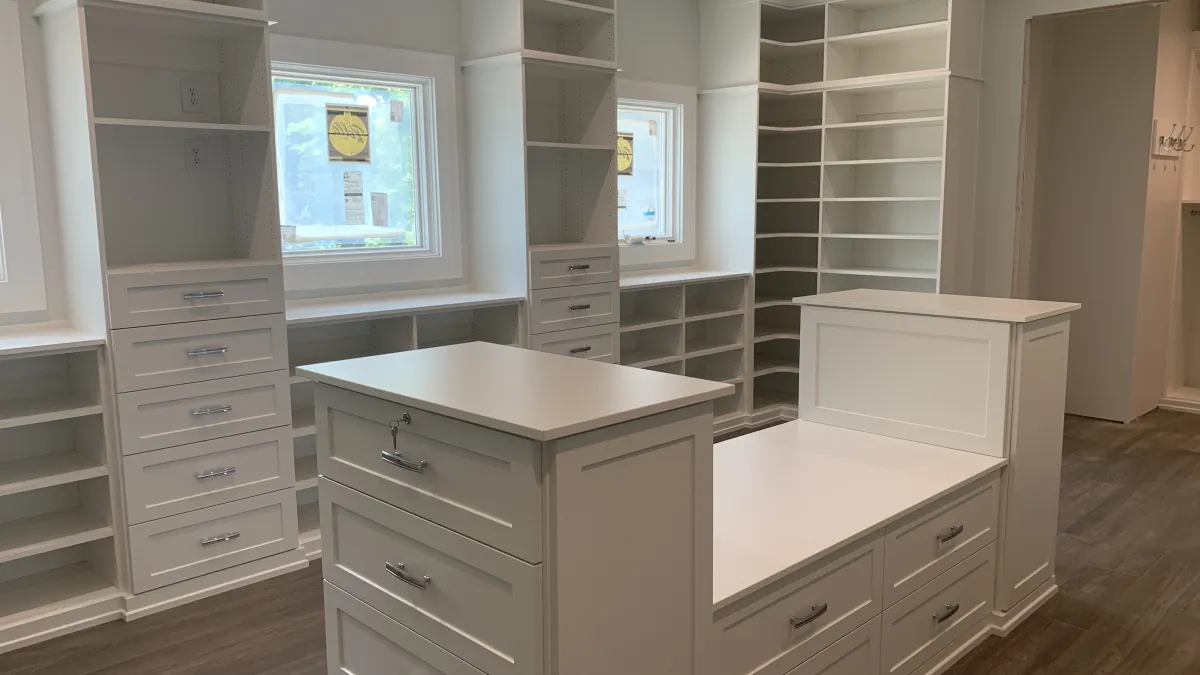 a closet with white cabinets