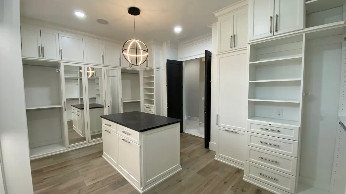 a closet with white cabinets