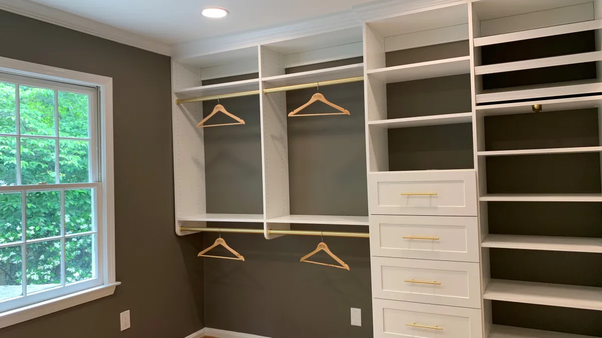 a room with white cabinets and a window