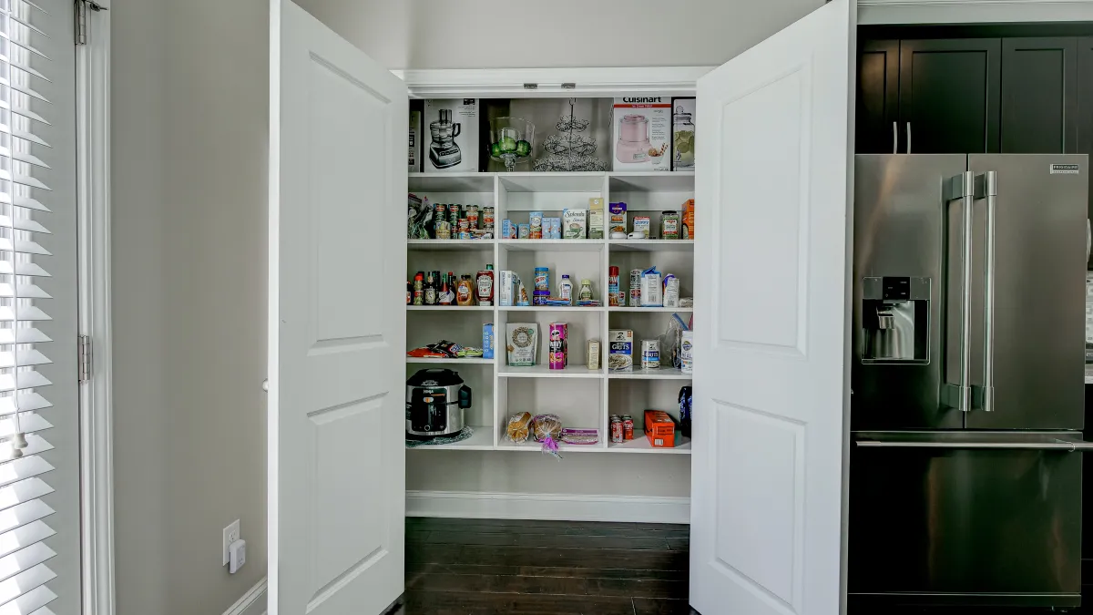 a pantry with white shelves