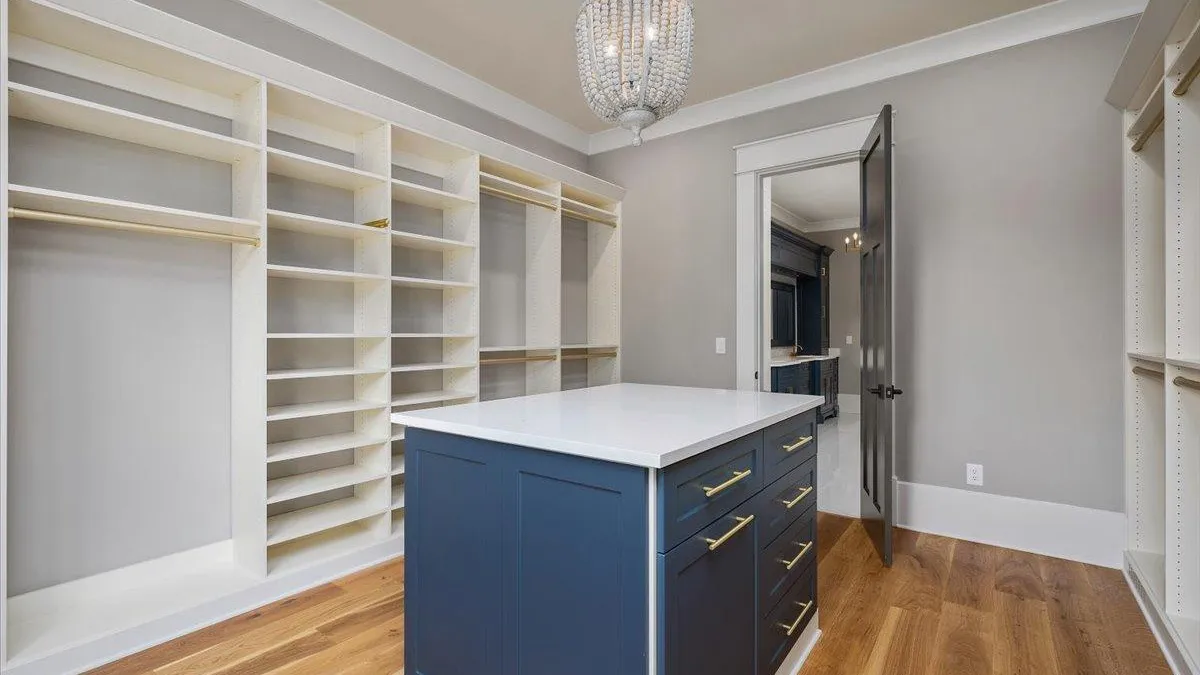 a closet with white cabinets