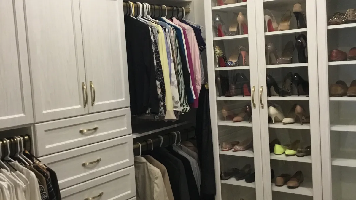 a closet with clothes and glasses