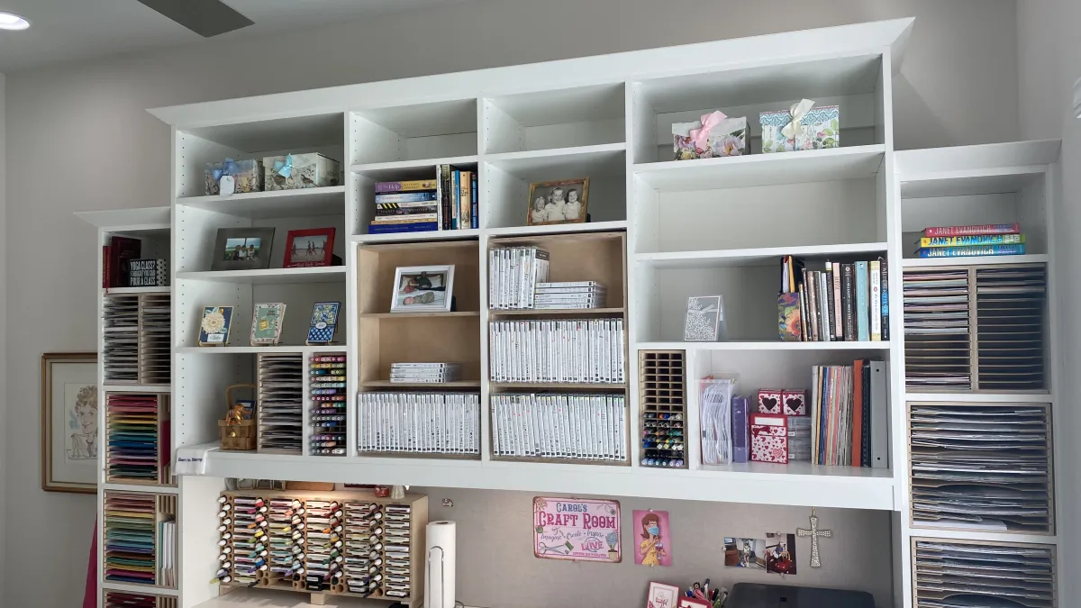 a white shelving unit with books