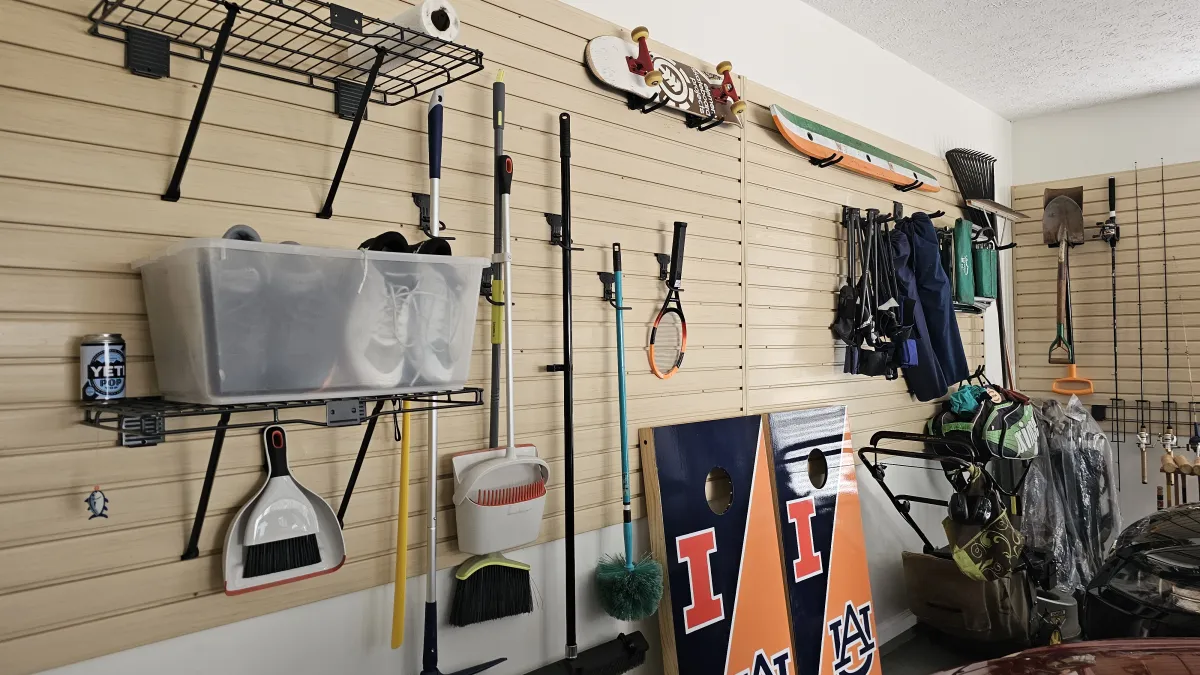 a room with a wall of clothes and a sign