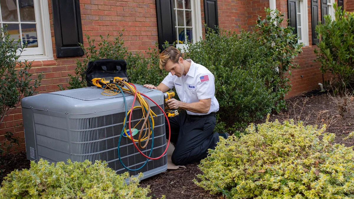 Bardi technician performing AC repair on an outdoor air conditioning unit