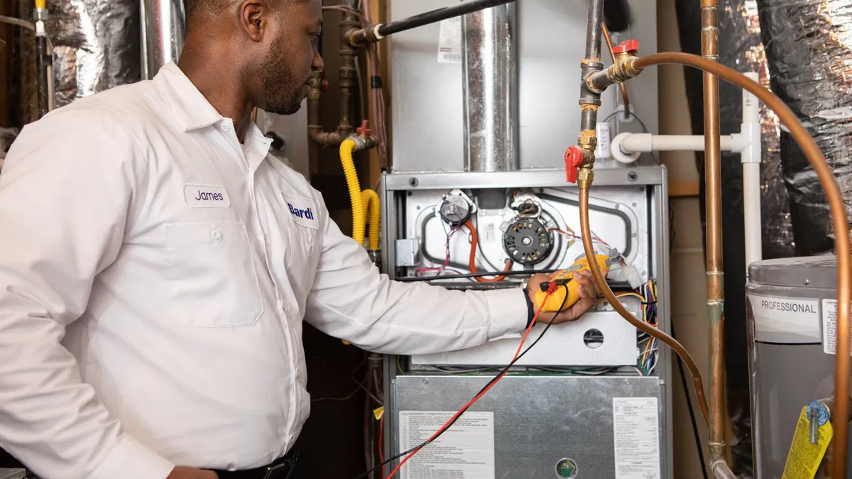 Bardi technician inspecting a residential heating system for replacement