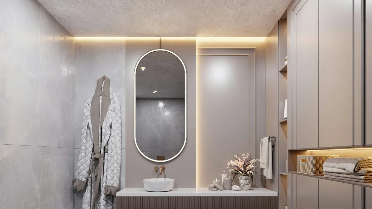 Modern bathroom with floating vanity, oval mirror, ambient lighting, robe on wall, and neatly organized shelves.