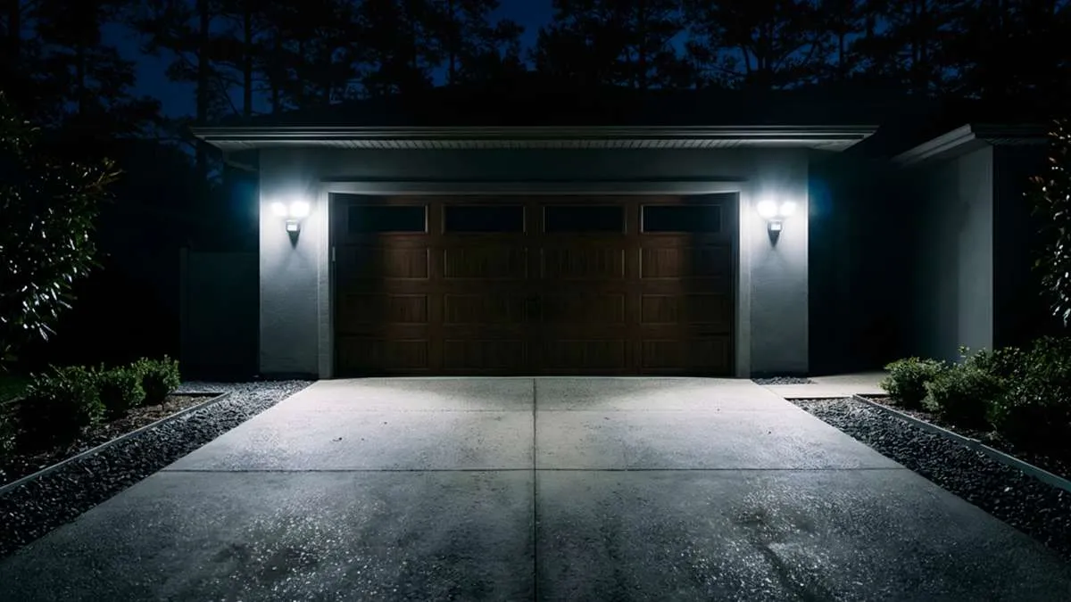 Outdoor security lighting installation in Atlanta illuminating garage and driveway with bright exterior floodlights at night