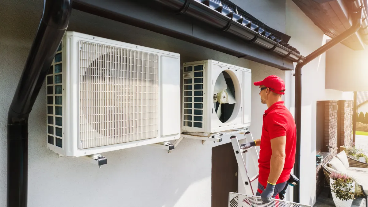 an hvac tech installing a heat pump in woodstock ga