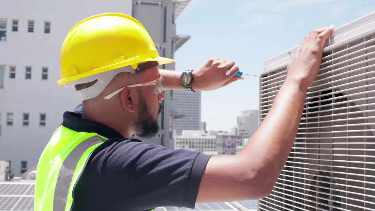 hvac technician servicing a commercial hvac unit