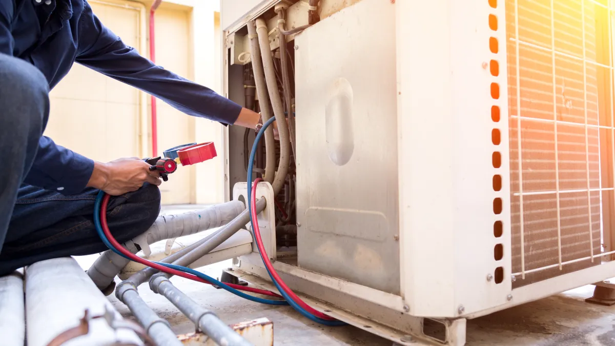 an hvac tech providing emergency ac repair in woodstock