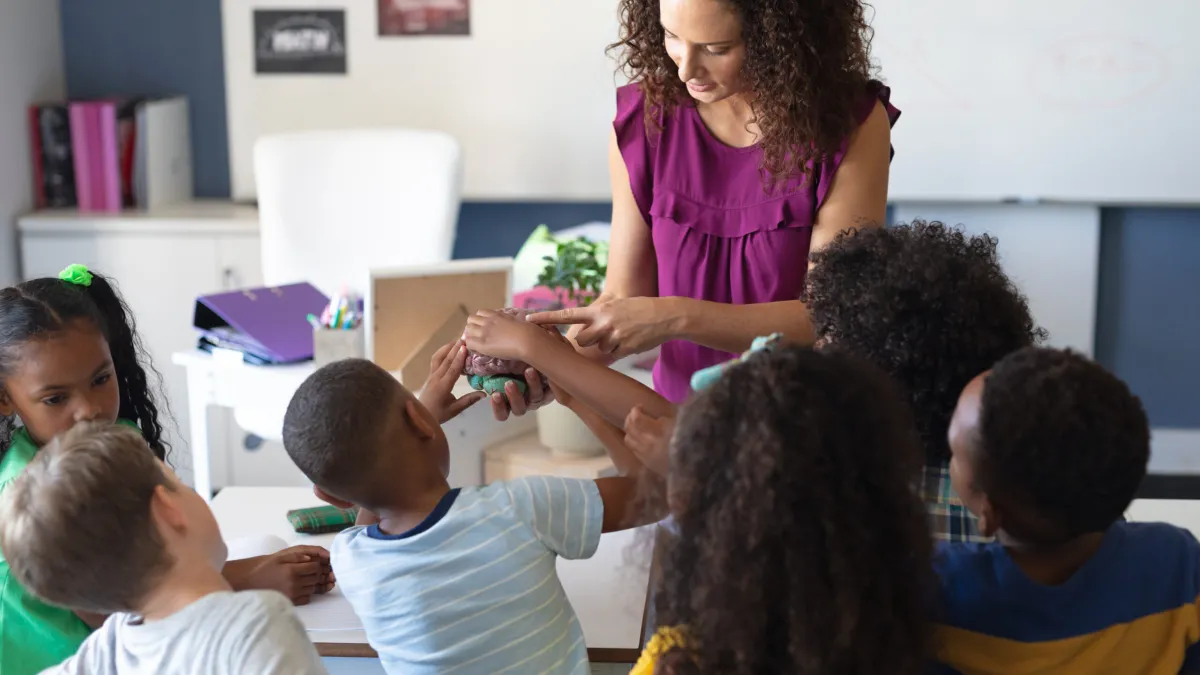 a teacher teaching her autistic students