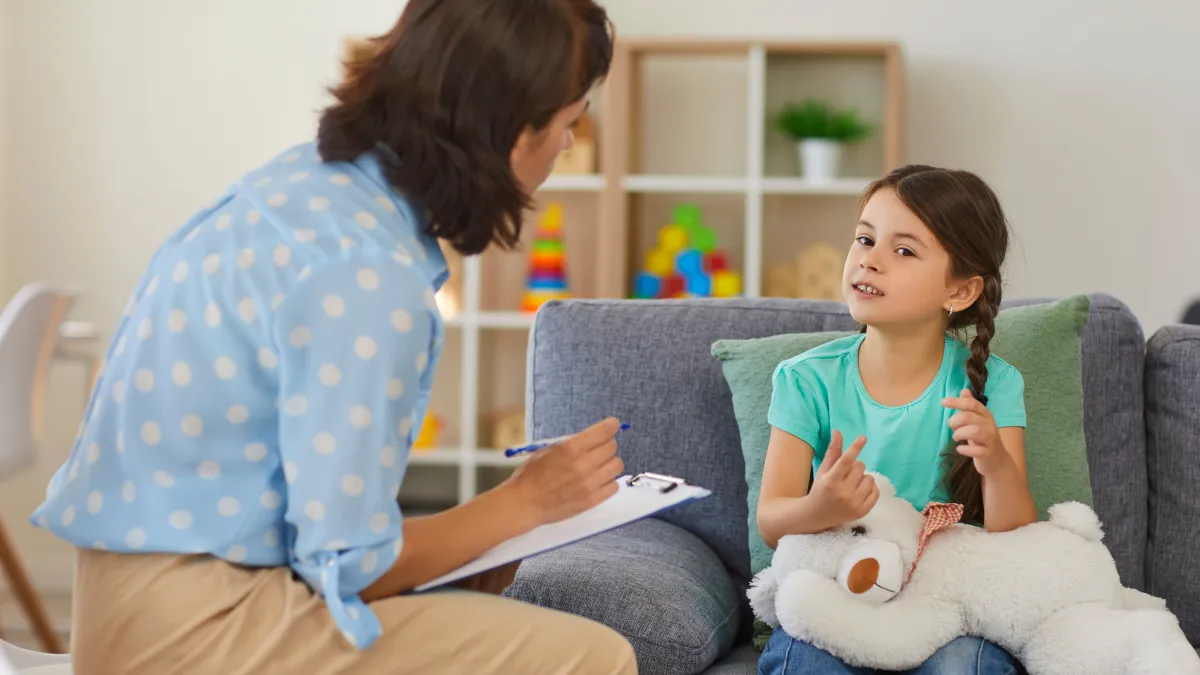 a teacher and a child with autism doing ABA therapy
