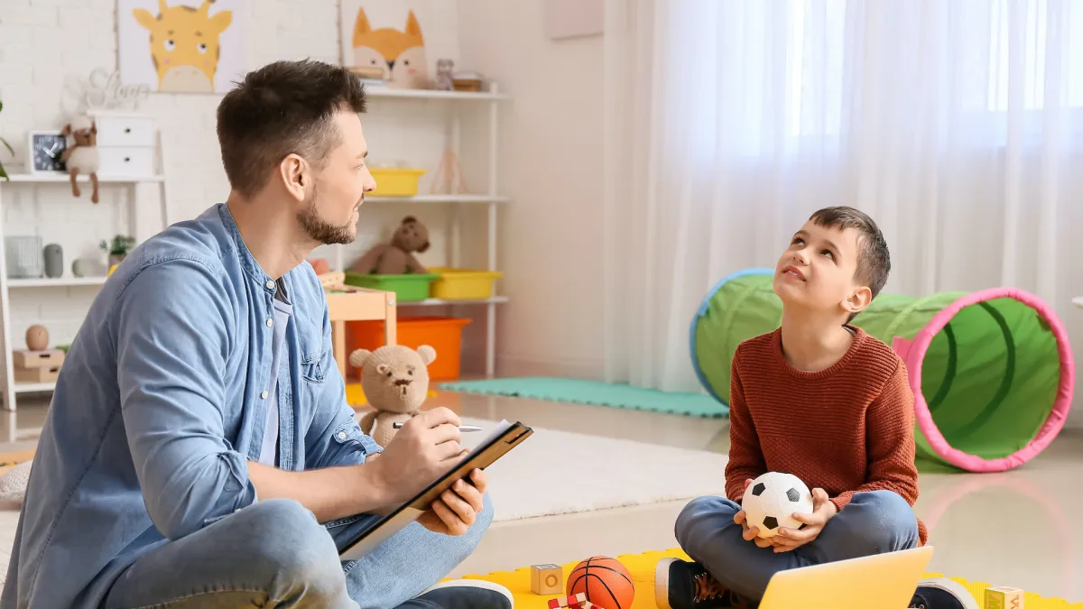 a teacher helping an autistic child in Cumming, GA
