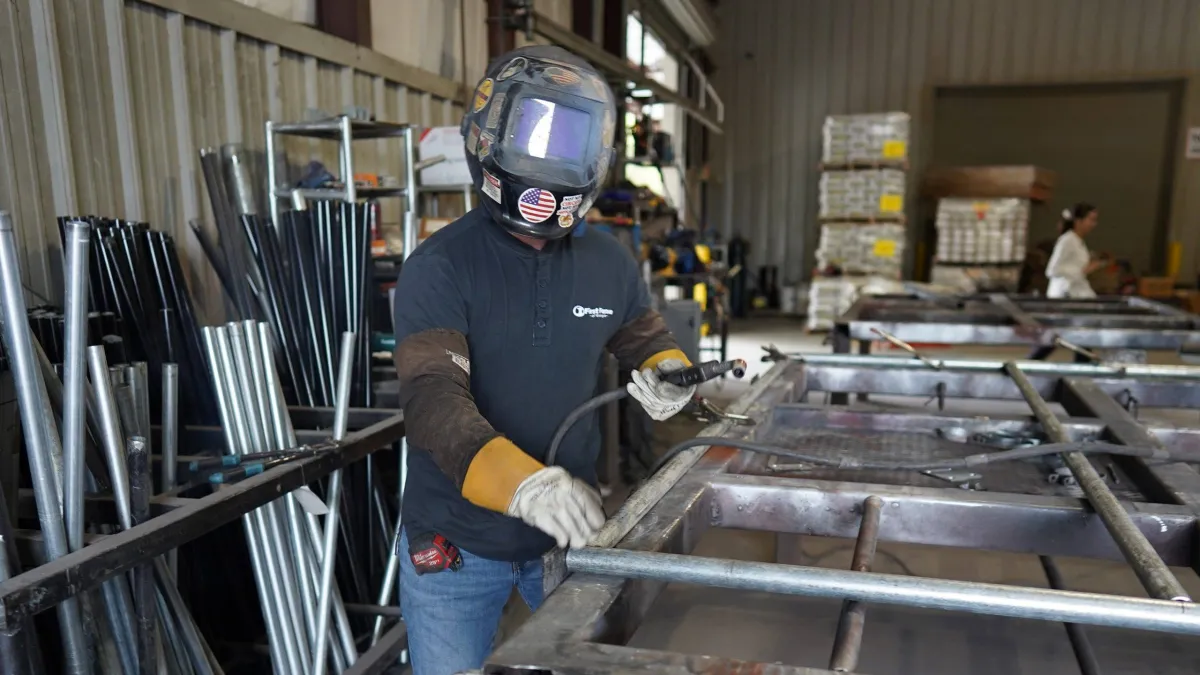 a man wearing a helmet working on a machine