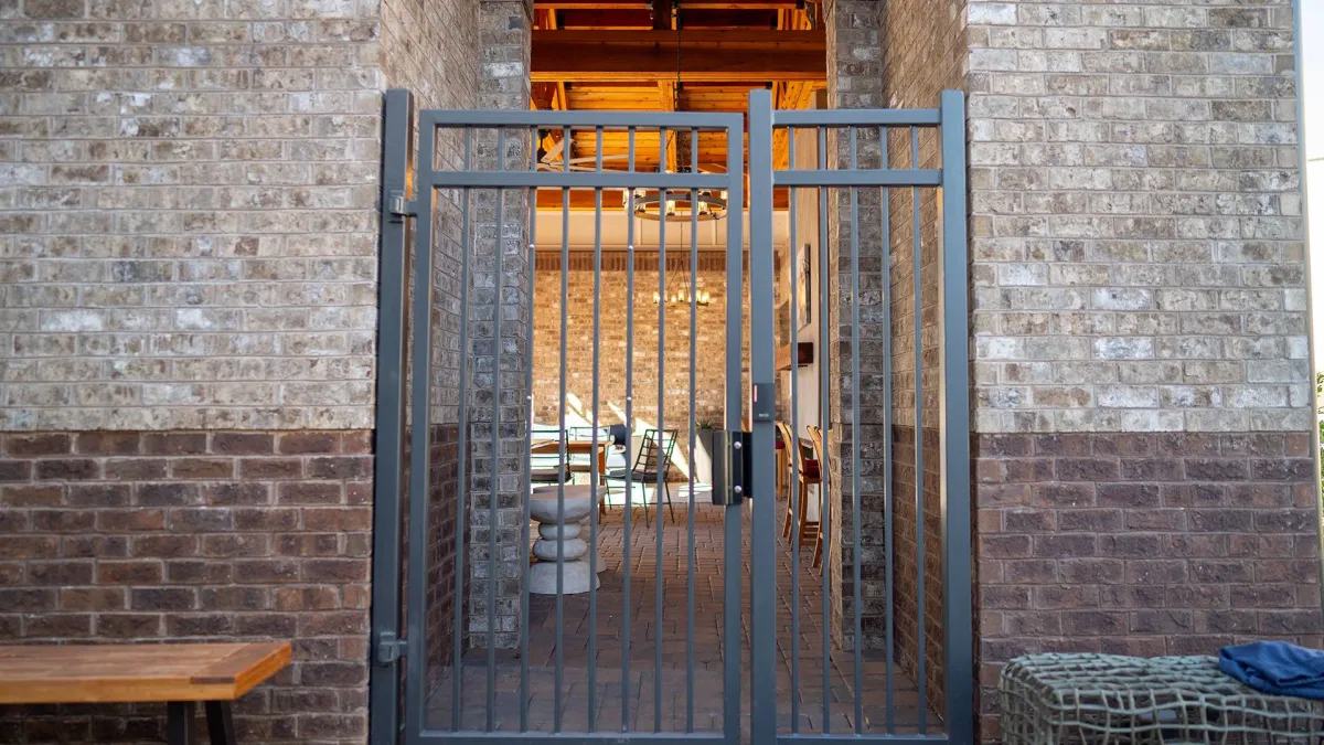 a gate in a brick building