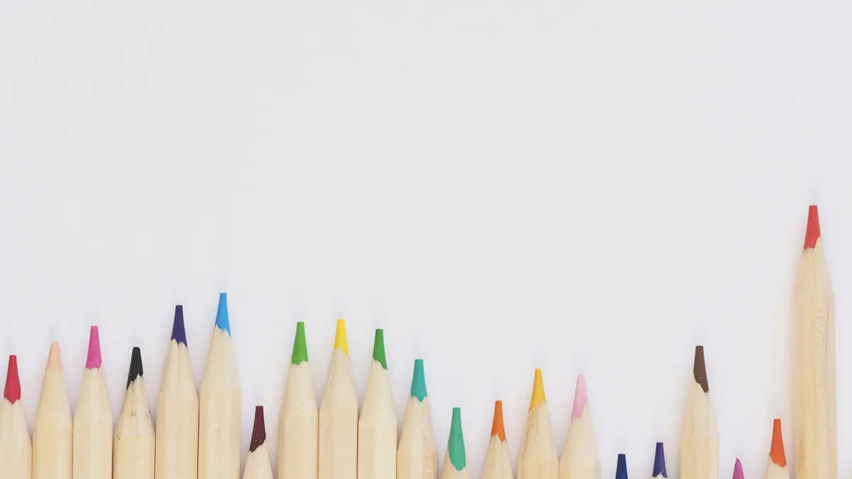 a group of colored pencils