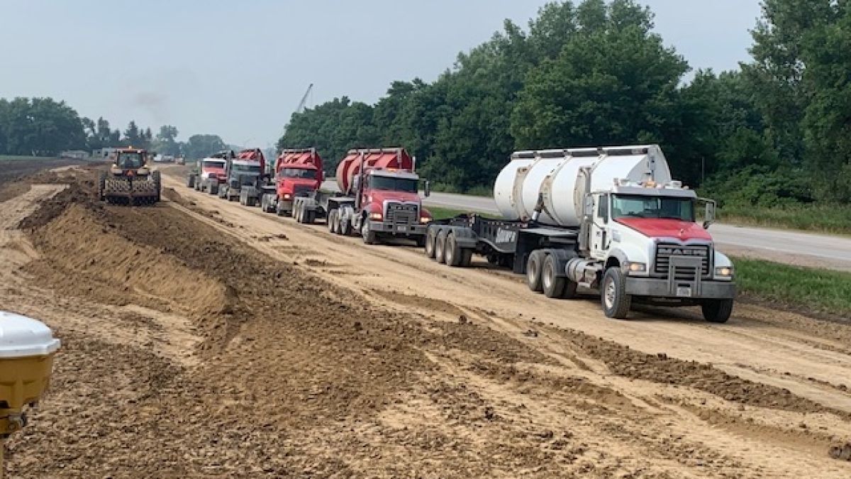a group of trucks on a dirt road