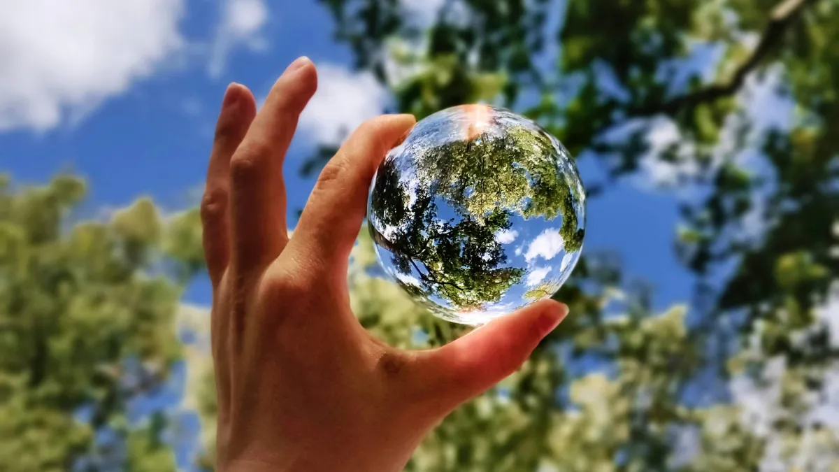 a hand holding a globe