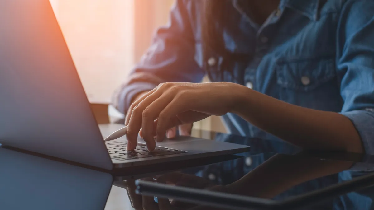 a person typing on a laptop