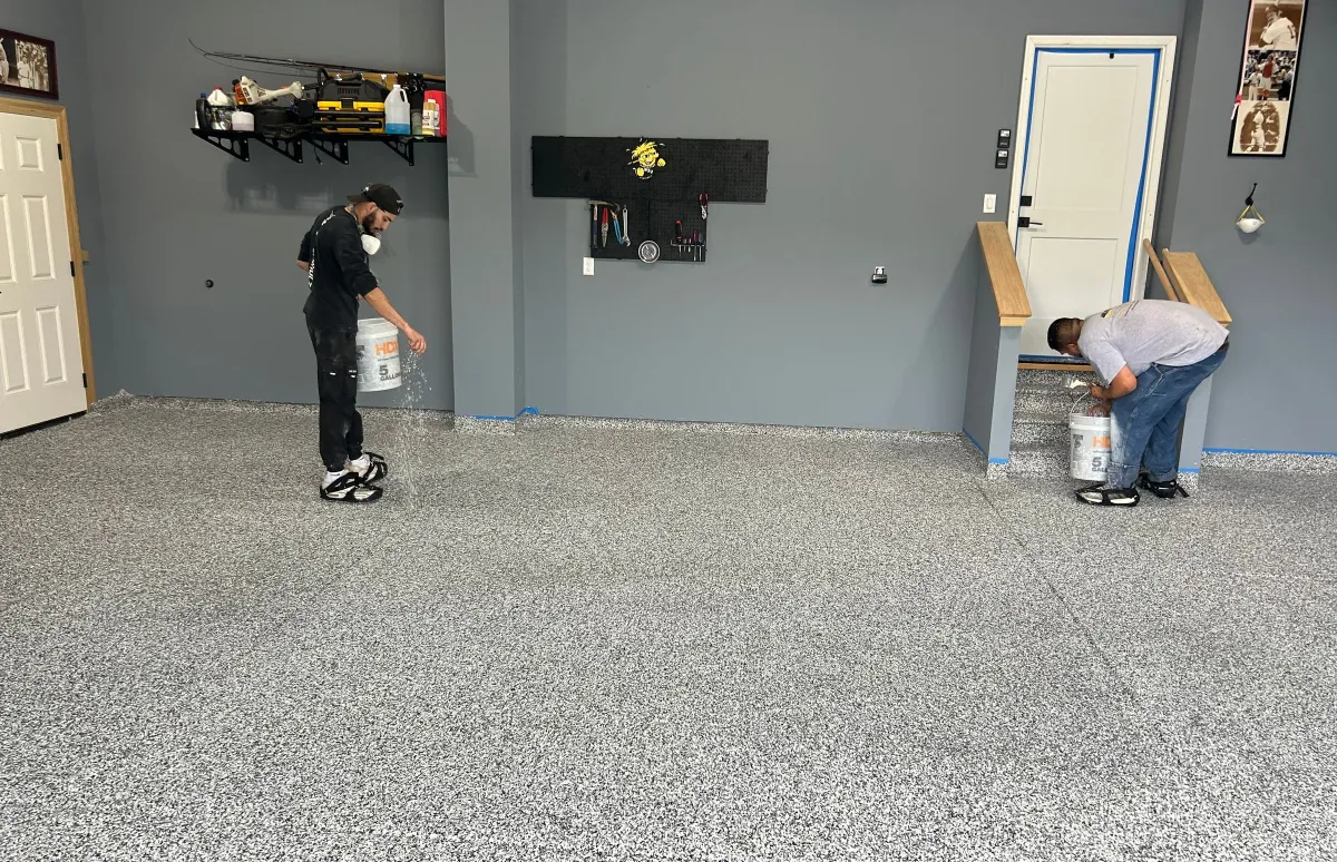 men spreading flakes on garage floors