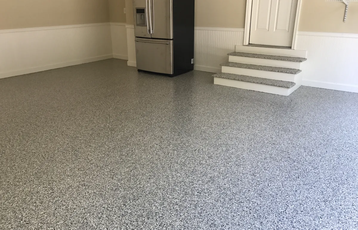 garage with steps and a refrigerator