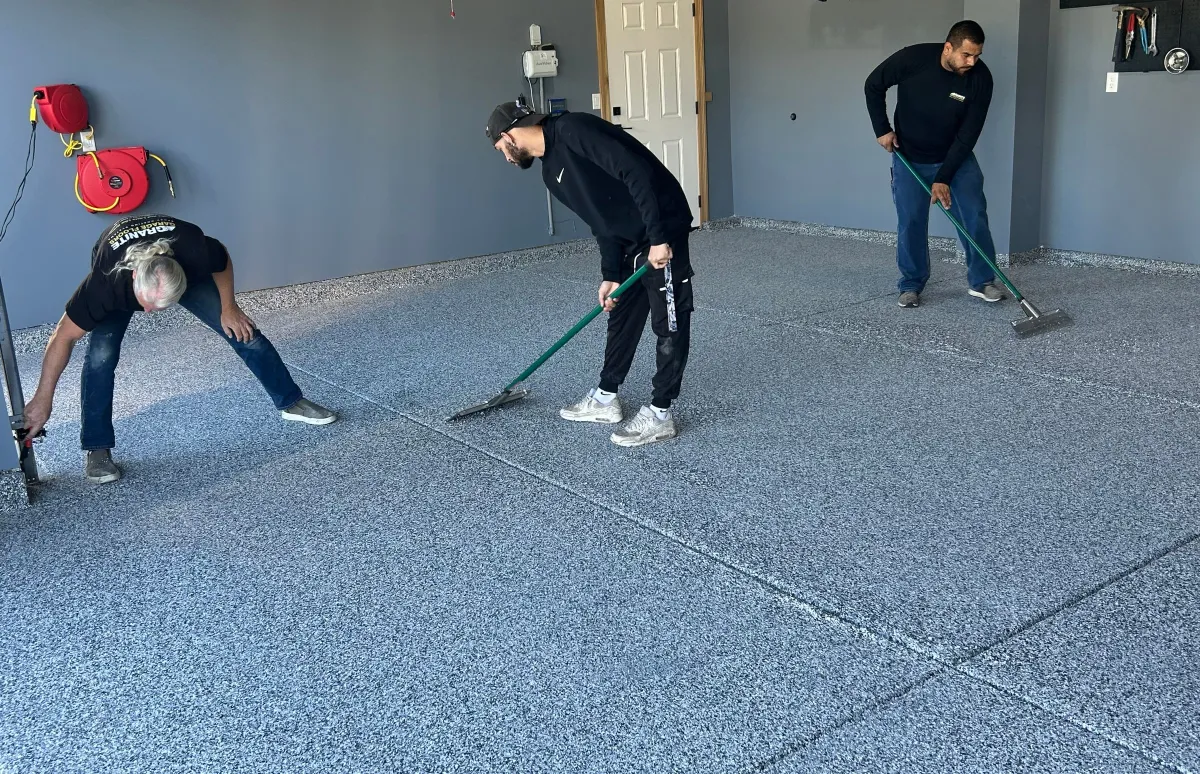 men scraping the a garage floor