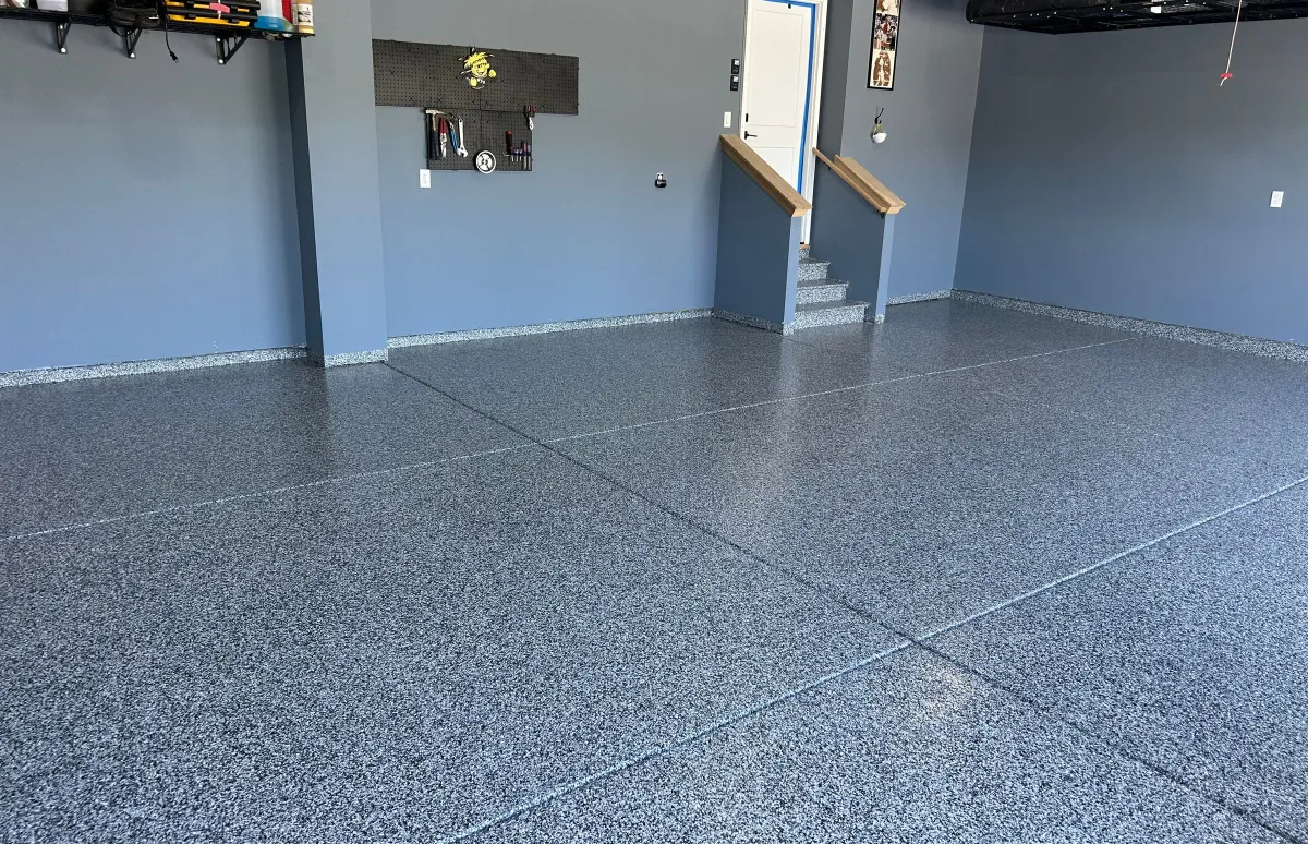 garage with black floor and blue walls