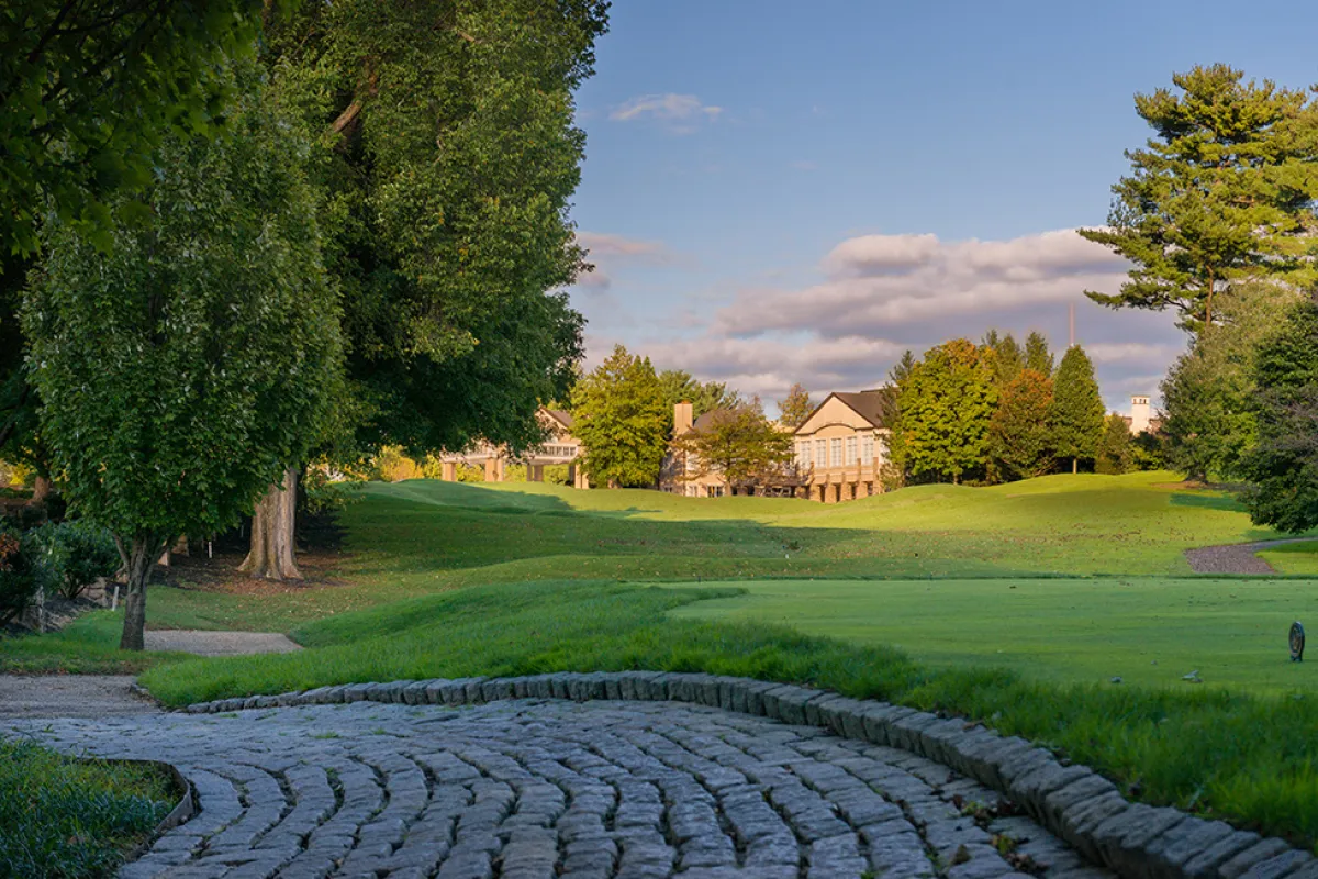 a stone pathway leading to a golf course