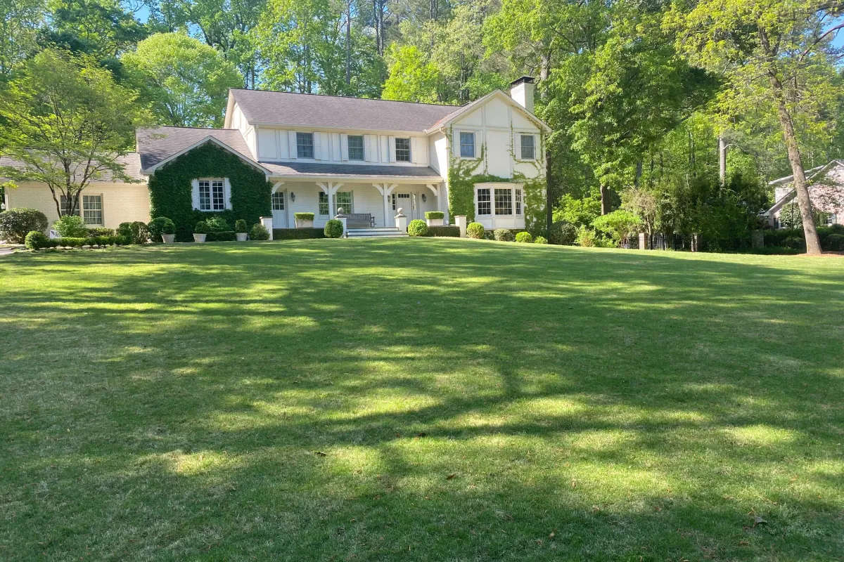 a large green lawn in front of a house