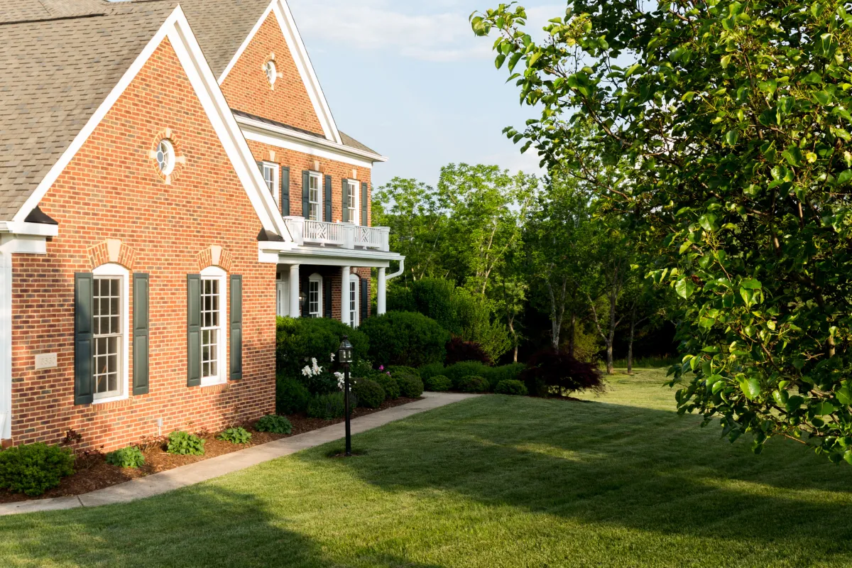 a brick house with a lawn