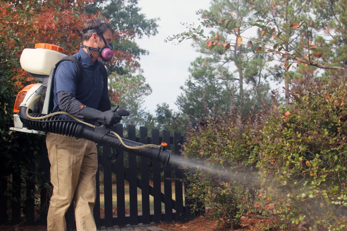 a man spraying mosquito control