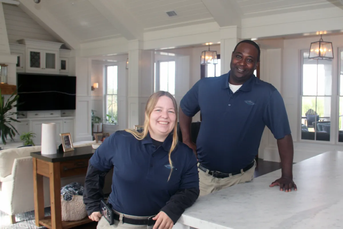 a man and a woman standing in a kitchen