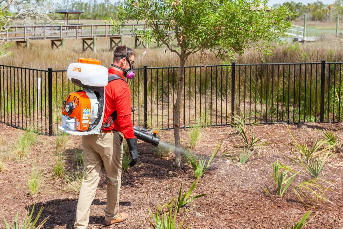 a man carrying a cooler