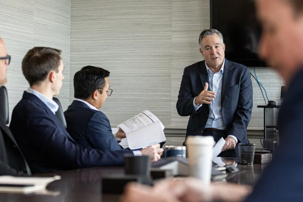 a group of men in a meeting