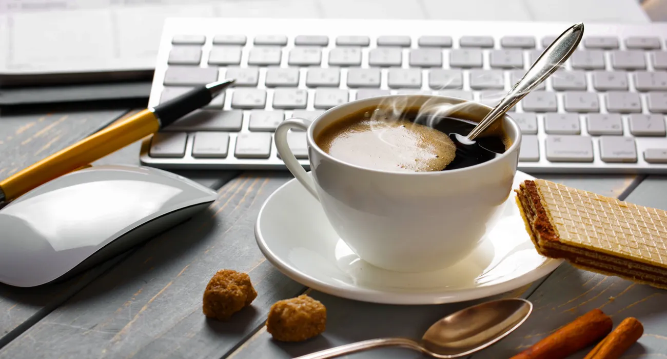 a cup of coffee and a spoon on a saucer