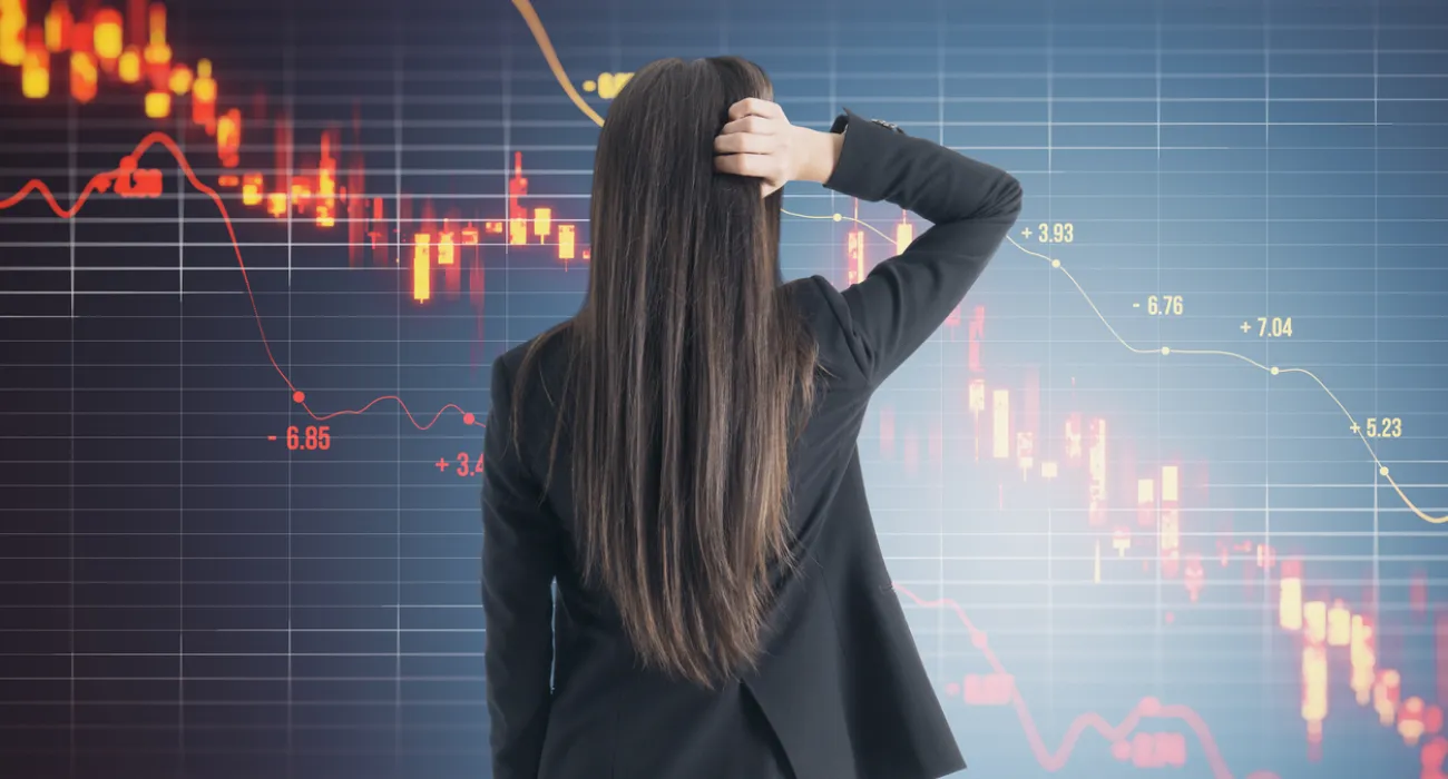 Businesswoman analyzing a stock market chart with red and green candlesticks, depicting market trends.