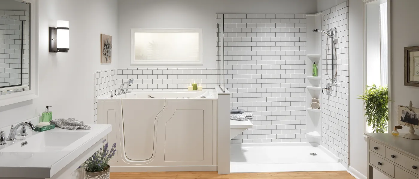 a bathroom with a walk in tub next to a ramped shower with a bench a sink and a rug