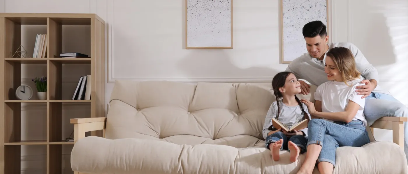 a family sitting on a couch