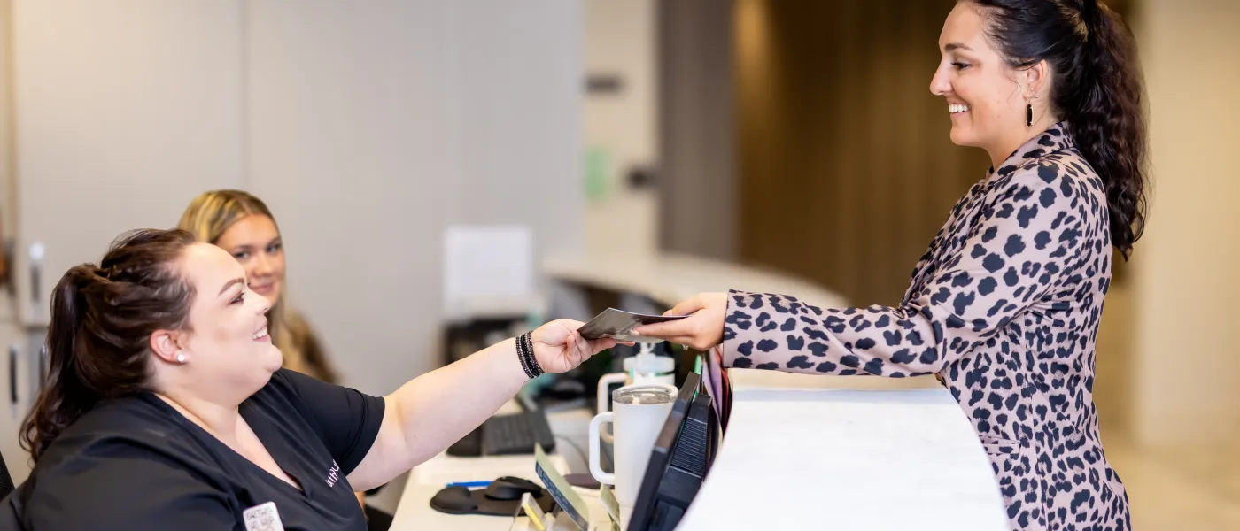 a person showing something to another woman